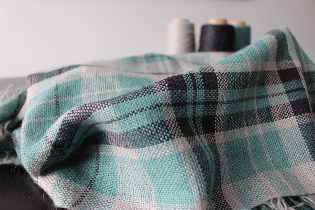 The finished plaid scarf woven on a rigid heddle loom