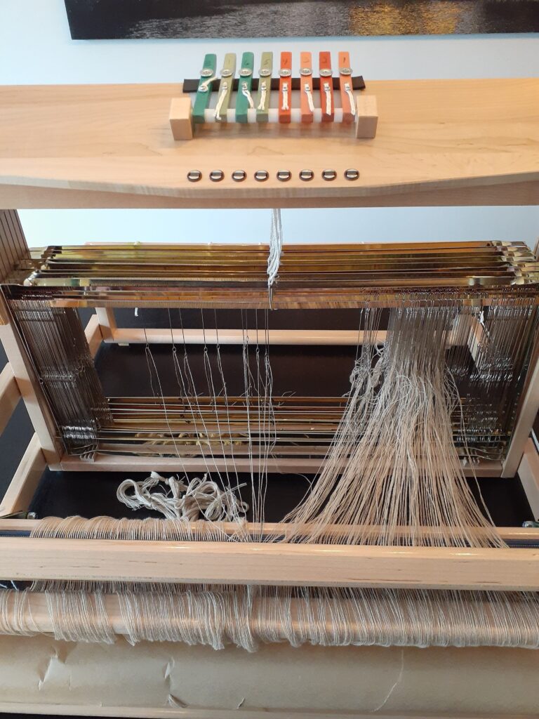 Threading a table loom